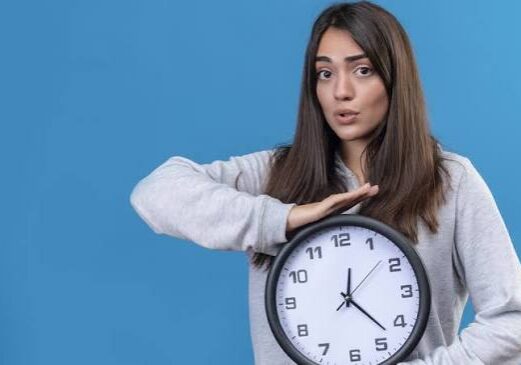 a girl holding a wall clock